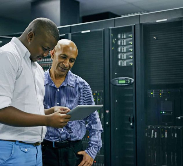 Shot of two IT technicians using a digital tablet while working in a data center